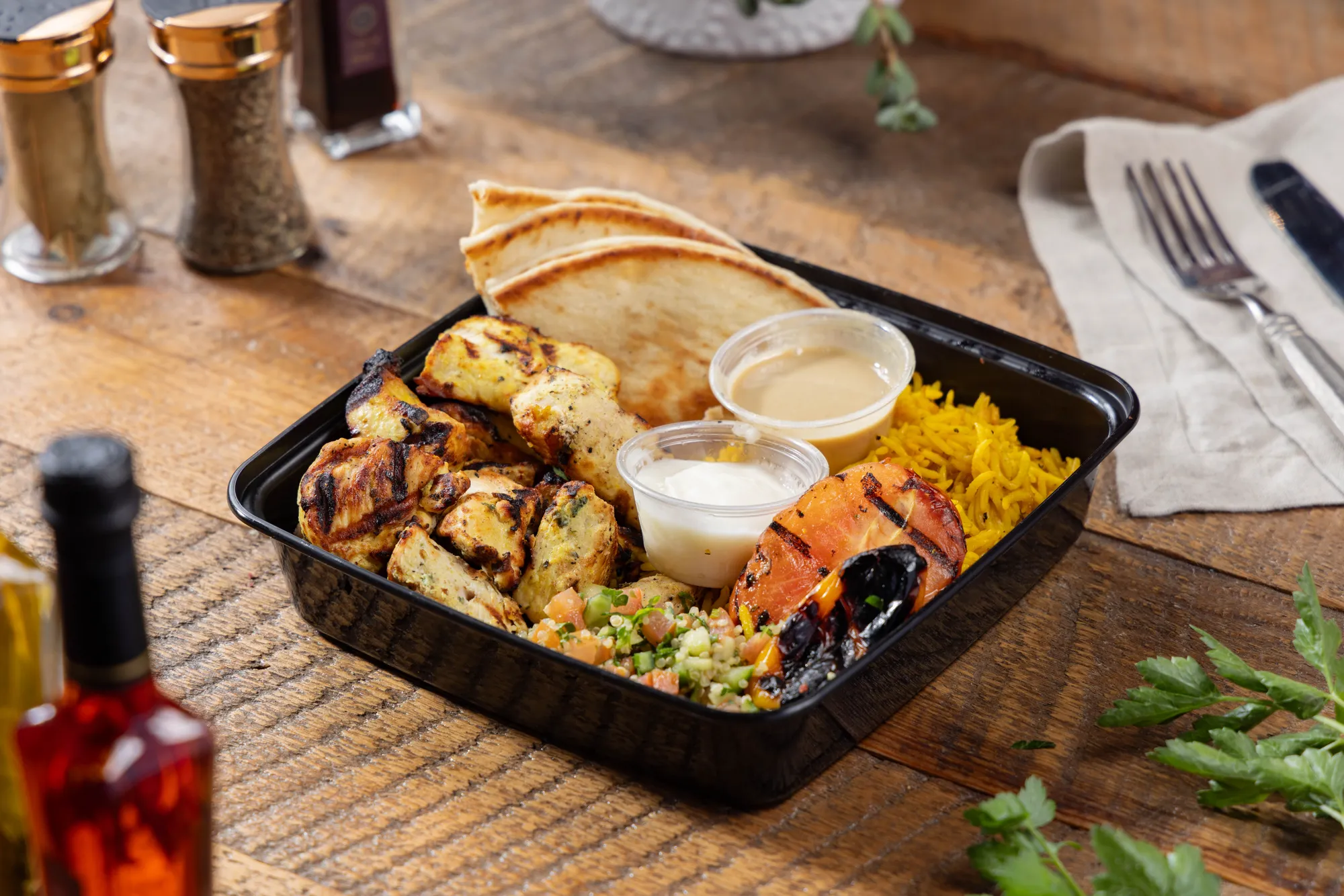 Fire-grilled chicken kabob plate from Ikaria Kitchen